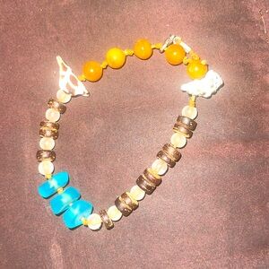 Adjustable bracelet with sea glass, wood beads and shells